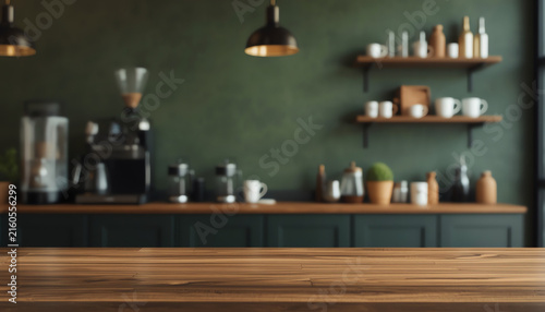 Wooden table top on blur kitchen room background,Modern Contemporary green kitchen room interior  