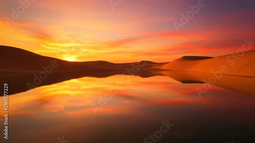 Golden sunset over rolling sand dunes with mirrored reflections
