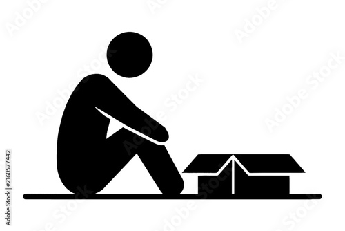 Silhouette of a person sitting next to an open cardboard box.