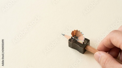 Pencil with a piece of paper stuck to it visualizing business simplification as removing unnecessary complexity to core