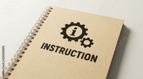 Spiral bound notebook with instruction word and gear icon printed on textured brown paper surface cover