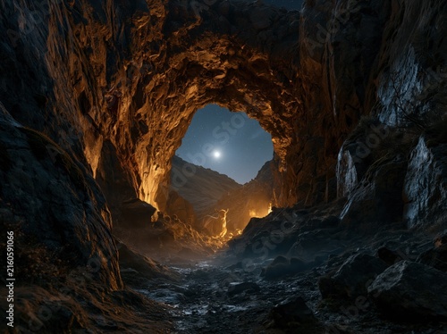 A stag standing in a rocky cave at night under a full moon