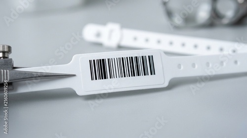 A Fresh Wristband Barcode Being Examined for Print Clarity before Attachment