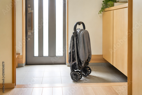 Baby stroller folded in entryway