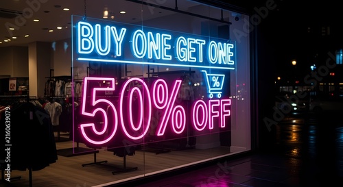 Buy one get one 50 percent off neon sign glowing in a retail storefront window at night for seasonal sales and marketing