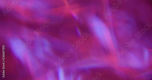 Defocused glow light. Art flare. Pink blue purple colorful lens glisten rainbow radiant kaleidoscope on abstract neon bokeh background.