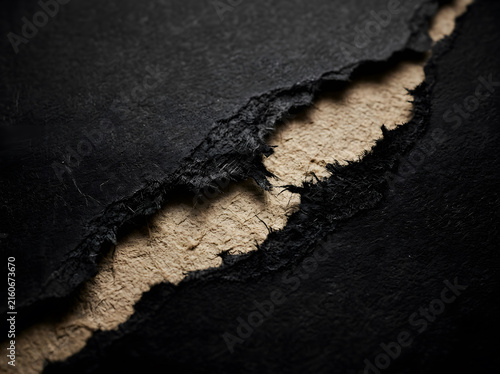 Torn black paper revealing beige underlayer with jagged edge texture for design mockups