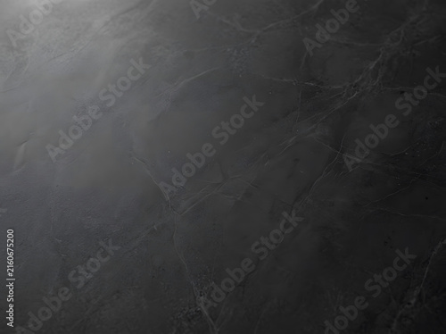 Dark gray marble texture with natural veining and matte finish for luxury surfaces
