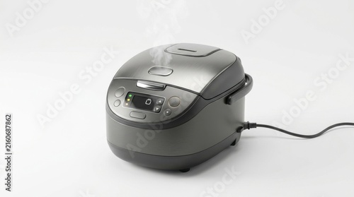 Modern metallic rice cooker steaming on white background