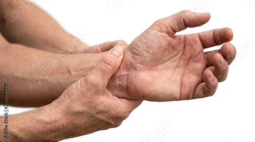 Close up of a senior person holding their painful wrist