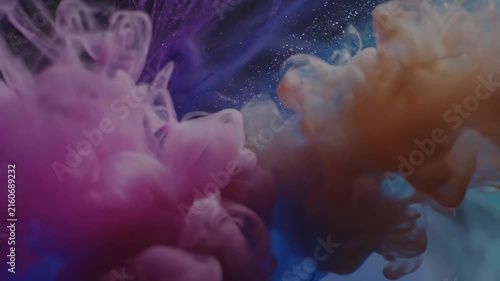 Colorful ink clouds drifting in deep blue water, dreamy abstract scene
