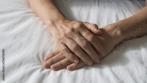 Gentle Hands Resting on Soft White Fabric in Serene Environment