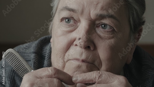 Thoughtful Elderly Woman Deep in Contemplation in a Soft Indoor Light