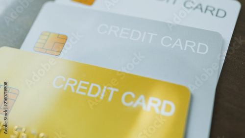 Cashless society concept, Close-Up silver and gold credit cards place on wooden desk table.