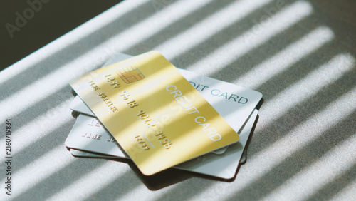 Smart spending options, Stacked of multiple credit cards on desk under soft window blind light. business credit concept.