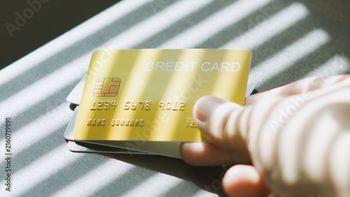 E-commerce transaction, hand reaching to grab credit card on office table for digital banking. payment business idea.