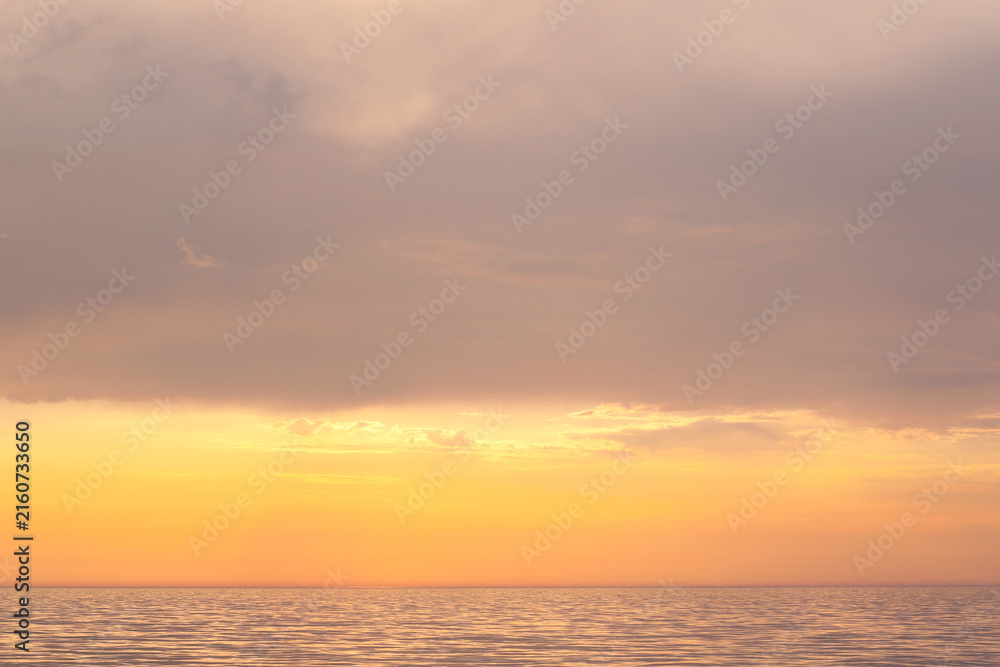 Fototapeta premium calm golden sunset over the sea