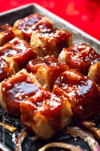 Glazed Sesame Tofu Cubes on Hot Plate with Savory Sauce