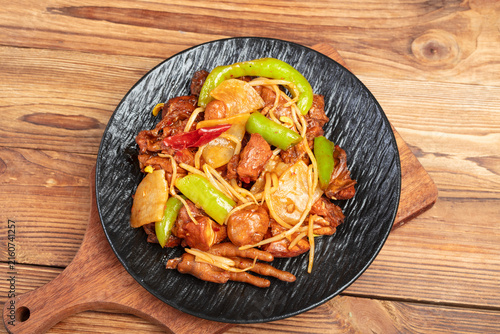 Stir Fried Chicken with Peppers and Onions on Rustic Wooden Table