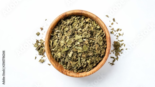 Damiana dried herb in wooden bowl isolated on white background