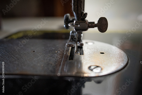 Obraz na płótnie Close-up of a vintage sewing machine needle and presser foot with soft ambient l