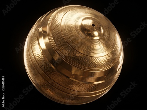 Metallic golden sphere featuring lathed grooves and a hammered cymbal texture isolated on a dark background.