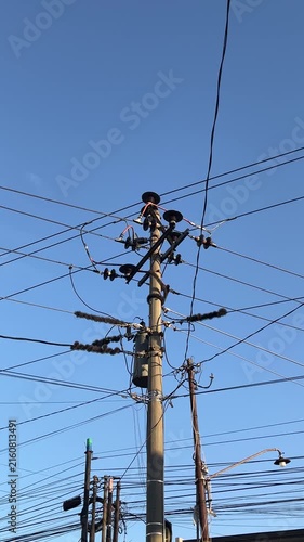 Electrical pole with electrical cables. Energy or power image, Infrastructure. electric. building. cable. high, top. voltage. line, lines. industry, industrial. clear blue sky. copy space, empty, free