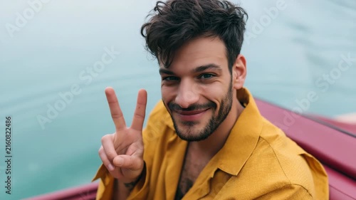 Closeup smiling man showing peace sign on a boat for travel social media background and banner use