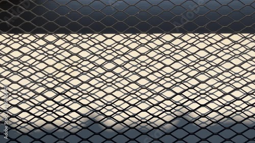 side view of black gate trellis. shadows reflection. door. dark, shadows. sunlight, sunshine. background, backgrounds. close up view. nobody, no people. copy space, empty, free, negative, text, design