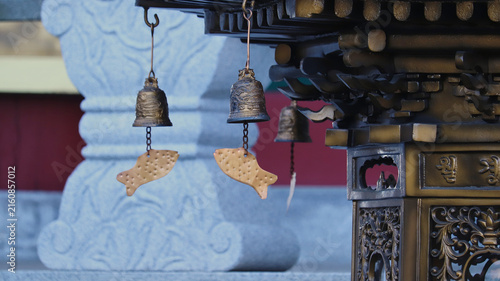 Canvas Print Traditional Asian Bronze Temple Bells with Detailed Fish Wind Chimes Hanging fro
