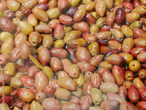 Принти на полотні a close-up overhead view of dark purple-red, almond-shaped olives submerged in