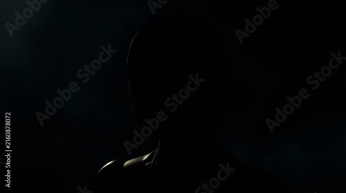 4K Dark silhouette of a humanoid AI robot assistant isolated against a black background, creating a futuristic and mysterious representation of artificial intelligence, robotics, automation