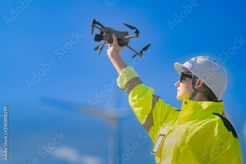 Quadro su tela An inspection drone lifts off the outstretched hand of a female technician, roto