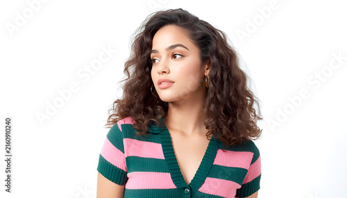 A close-up portrait of a girl in a striped blouse with voluminous dark hair, an attentive gaze, natural beauty, studio photo against a white background.