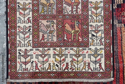 A detail of a carpet featuring traditional motifs. An example of the Turkish art of hand-weaving, showcasing geometric and floral patterns.