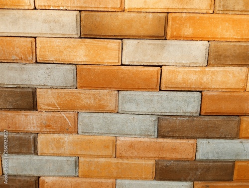 Canvastavla Close-up view of a brick wall with warm orange, brown, beige, and gray tones arranged in a traditional masonry pattern