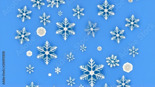 Falling snowflakes with gentle motion against a bright blue background during winter holidays