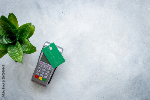 Contactless payment with credit card on POS terminal — cashless transaction, fintech concept, top view flat lay.