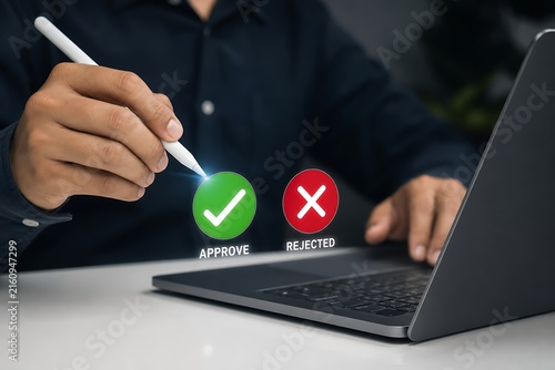 Hand pointing stylus at laptop with approved and rejected icons on screen
