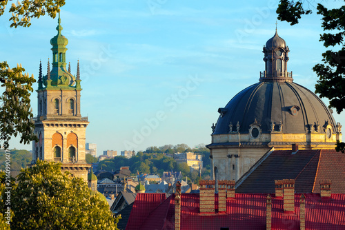 Photography Historic European city skyline with prominent tower and dome architecture