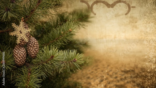 Pine Branch with Pinecones and Gold Snowflake Ornament in Rustic Background