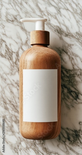Natural wood soap dispenser with white label on marble background