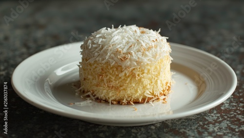 Coconut Cake on a White Plate with a Rustic Background