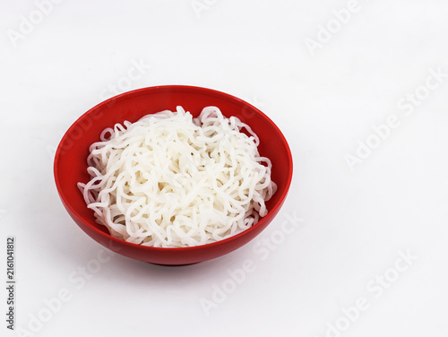 Red Bowl Filled with Cooked Konjac Shirataki Noodles Isolated on White Background