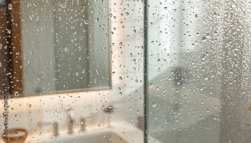 Raindrops on a Glass Shower Screen with Blurred Bathroom Reflection