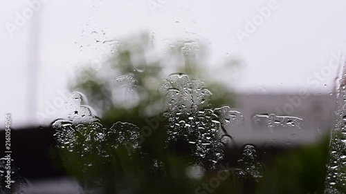 Car windshield with rain drops and frameless wiper blade,Traffic Jam with raining in evening day in the city,Drops of water on the car after rainy,outside car,Raindrops falling on a glass