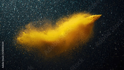 Yellow Dust Cloud Forming in the Air Against a Dark Background