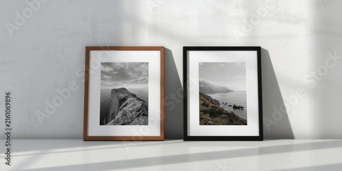 Framed Black and White Landscape Photographs on a Minimalist Shelf with Natural Light