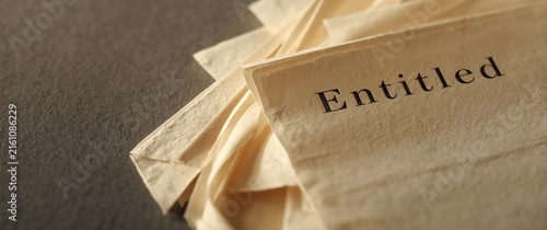 Stack of Old Papers with the Word Entitled on Top in Warm Light
