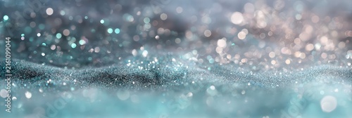 A dreamy abstract background featuring teal and silver glitter with soft bokeh lights. Sparkling highlights and shimmering textures create a magical celebration mood.